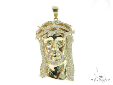 Yellow gold Jesus pendant with prong-set diamonds and detailed facial features.