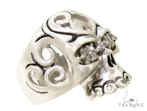 Silver men's skull ring with prong-set diamonds and intricate swirling details