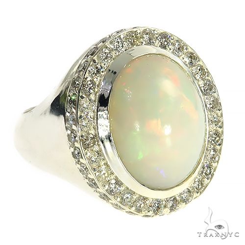 Silver ring with oval opal center stone surrounded by small sparkling gemstones