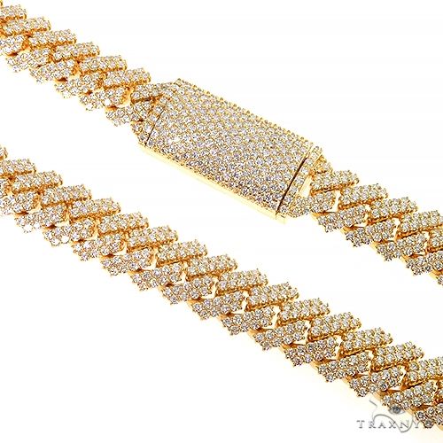 Prong set diamond Cuban link chain in yellow gold – close-up showing round diamonds in individual prong settings
