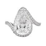 Pear-shaped diamond engagement ring with pavé diamond band in white gold.