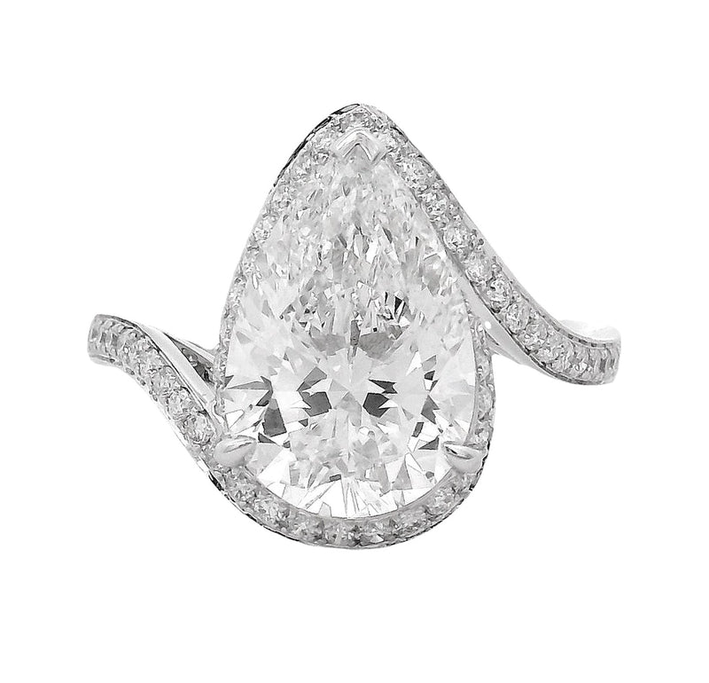 Pear-shaped diamond engagement ring with pavé diamond band in white gold