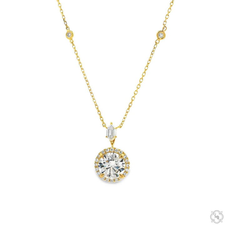 18K gold round cut diamond halo drop necklace with pavé halo, baguette accent, and bezel-set station chain