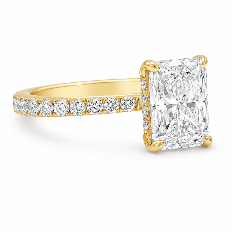 Yellow gold engagement ring with radiant-cut diamond and small side diamonds on a tapered band.