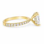 Yellow gold engagement ring with radiant-cut diamond and small side diamonds on a tapered band.