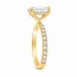Yellow gold engagement ring with radiant-cut diamond and small side diamonds on a tapered band.