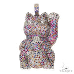 Cat figurine encrusted with multicolored sapphire crystals, raised paw design.