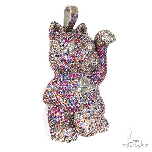 Cat figurine encrusted with multicolored sapphire crystals, raised paw design.