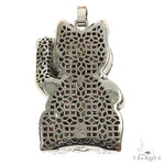 Cat figurine encrusted with multicolored sapphire crystals, raised paw design.
