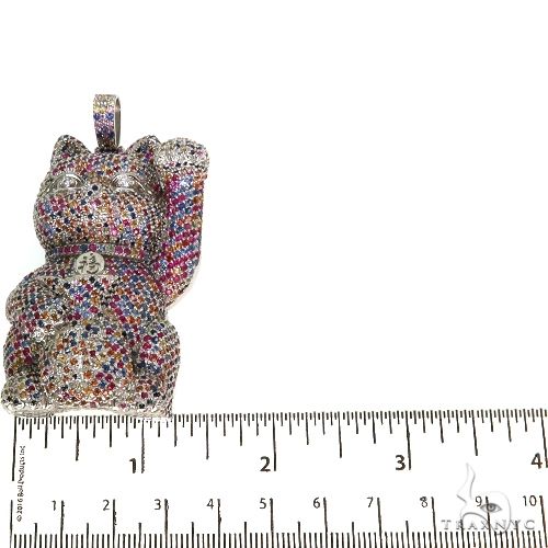 Cat figurine encrusted with multicolored sapphire crystals, raised paw design.