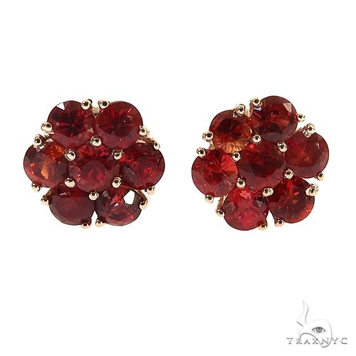 Small flower cluster earrings with red sapphire and diamond stones in a floral stud setting – front view