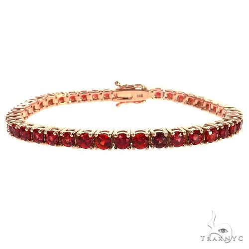 Rose gold tennis bracelet with round red sapphire gemstones in prong settings