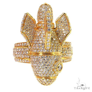 Yellow gold men's ring shaped like a rocket ship encrusted with numerous small diamonds.