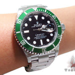 Rolex Submariner 16610 steel watch with black dial and green bezel, stainless steel bracelet.