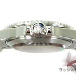 Rolex Submariner 16610 steel watch with black dial and green bezel, stainless steel bracelet.