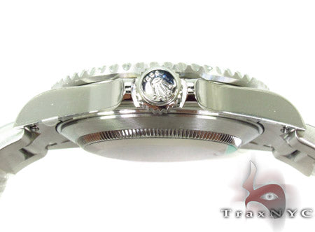 Rolex Submariner 16610 steel watch with black dial and green bezel, stainless steel bracelet.