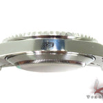 Rolex Submariner 16610 steel watch with black dial and green bezel, stainless steel bracelet.