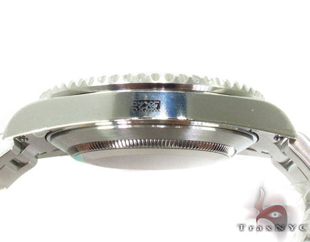 Rolex Submariner 16610 steel watch with black dial and green bezel, stainless steel bracelet.