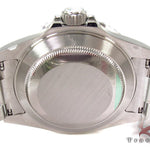 Rolex Submariner 16610 steel watch with black dial and green bezel, stainless steel bracelet.