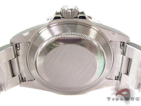 Rolex Submariner 16610 steel watch with black dial and green bezel, stainless steel bracelet.