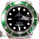 Rolex Submariner 16610 steel watch with black dial and green bezel, stainless steel bracelet.