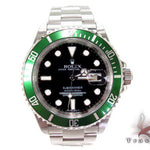 Rolex Submariner 16610 steel watch with black dial and green bezel, stainless steel bracelet.