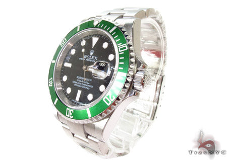 Rolex Submariner 16610 steel watch with black dial and green bezel, stainless steel bracelet.