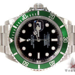 Rolex Submariner 16610 steel watch with black dial and green bezel, stainless steel bracelet.