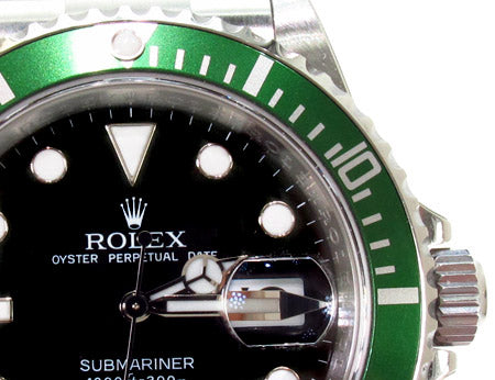 Rolex Submariner 16610 steel watch with black dial and green bezel, stainless steel bracelet.