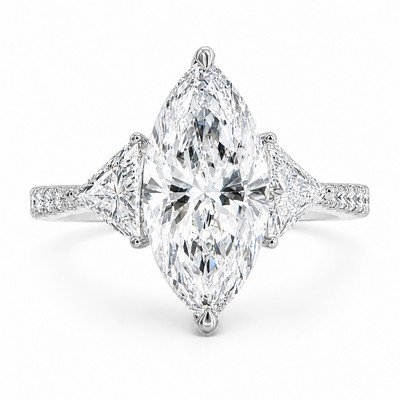Marquise-cut lab-grown diamond three-stone engagement ring with trillion side stones and pavé diamond band.