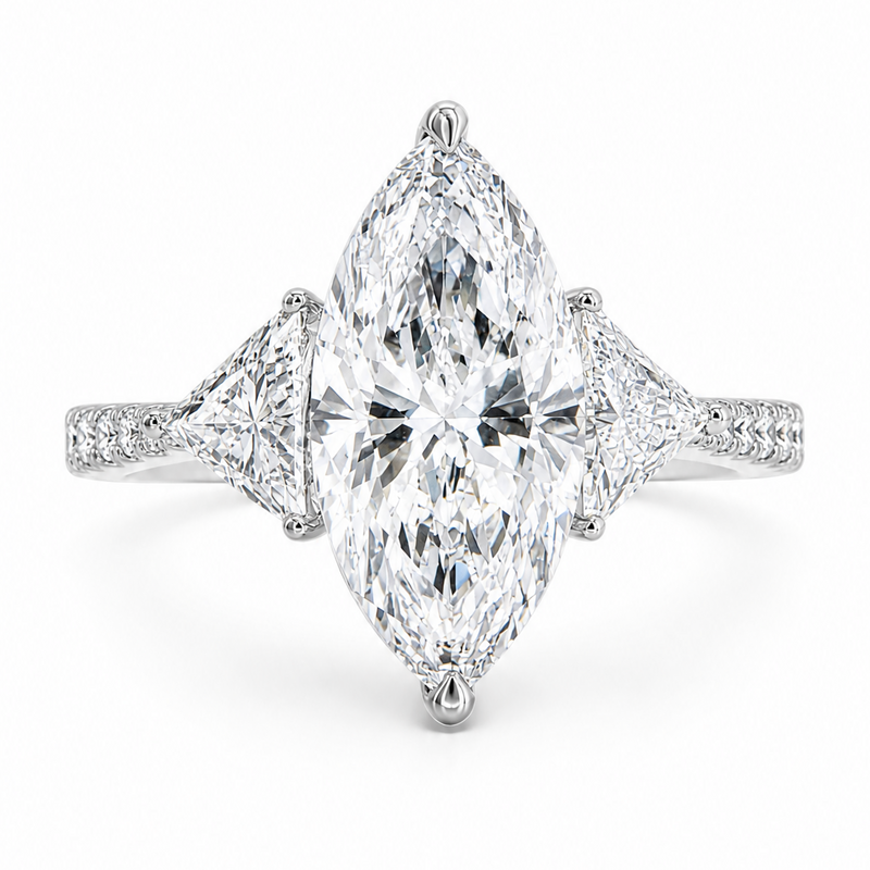 Marquise-cut lab-grown diamond three-stone engagement ring with trillion side stones and pavé diamond band.