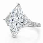 Marquise-cut lab-grown diamond three-stone engagement ring with trillion side stones and pavé diamond band.