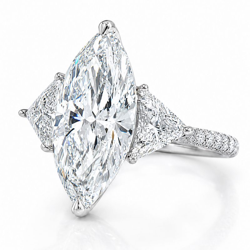 Marquise-cut lab-grown diamond three-stone engagement ring with trillion side stones and pavé diamond band.
