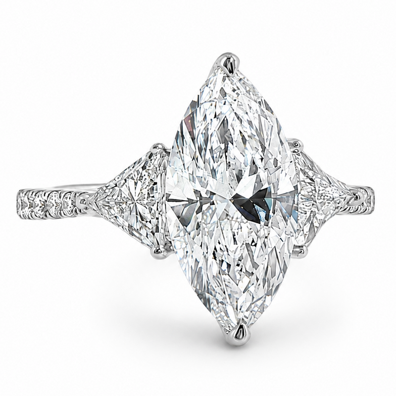 Marquise-cut lab-grown diamond three-stone engagement ring with trillion side stones and pavé diamond band.