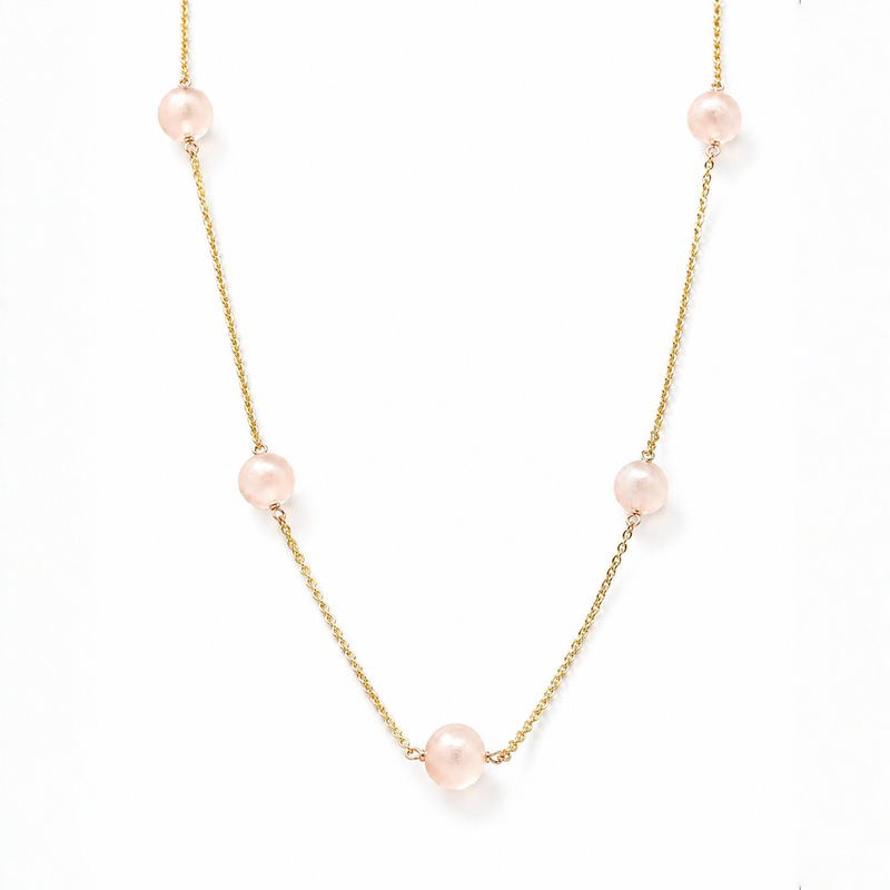 Delicate gold chain necklace with evenly spaced soft pink pearls for women.