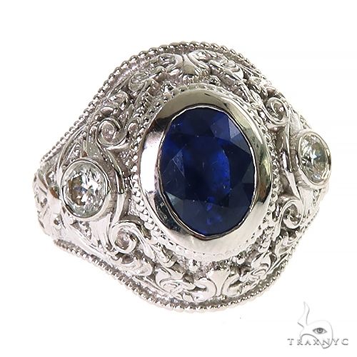 Silver men's ring with oval blue sapphire and intricate engraved floral details