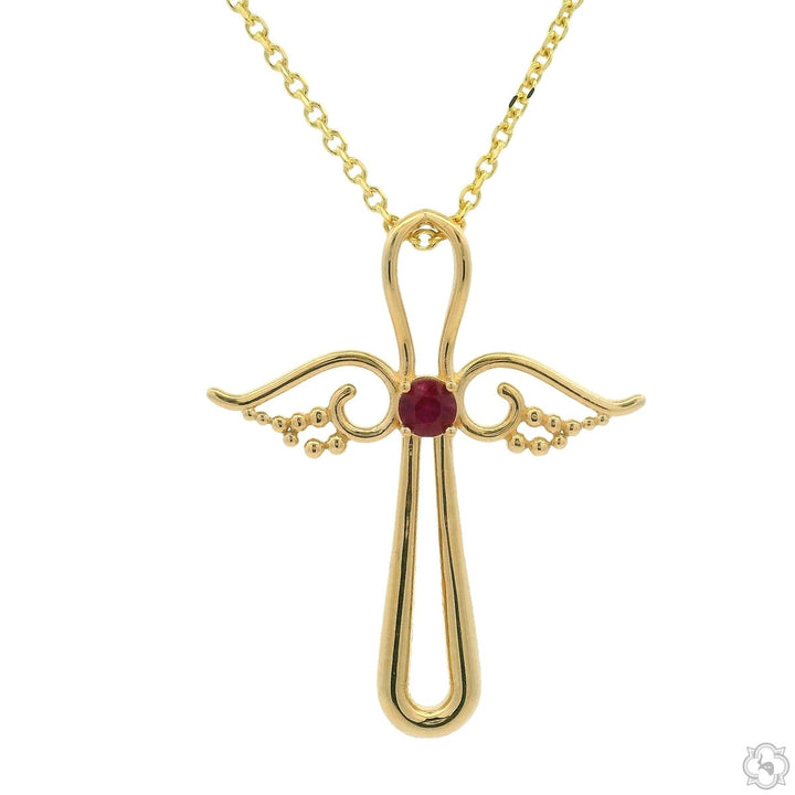 Yellow gold angel cross pendant with central ruby and delicate wing detailing on chain.