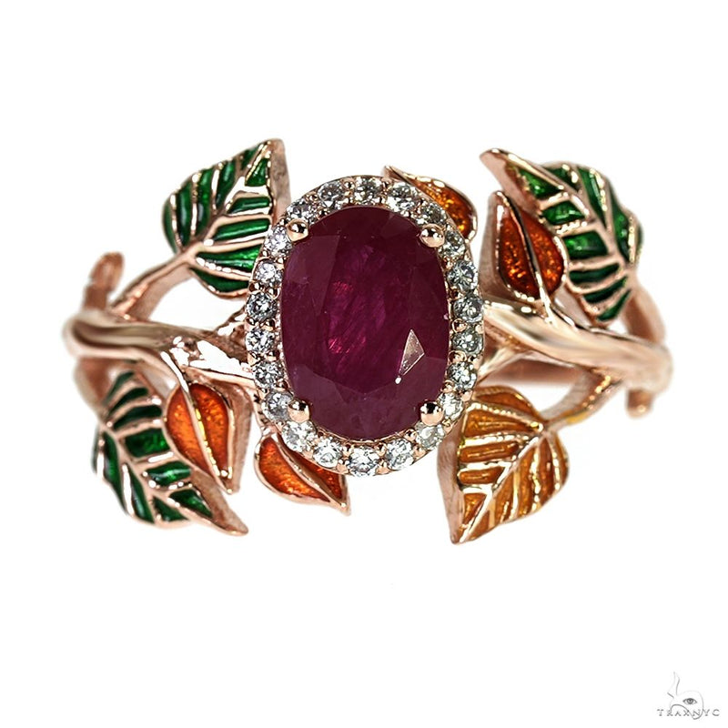 Gold floral ring with oval ruby center stone and sparkling clear accents