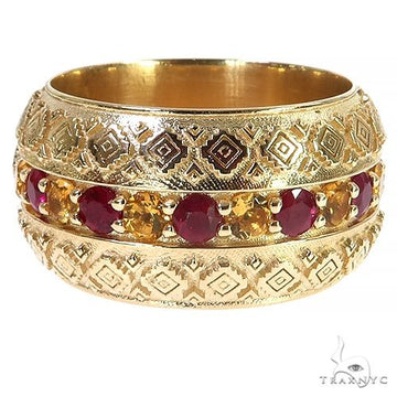 Yellow gold band ring with alternating ruby and citrine gemstones and intricate diamond patterns.