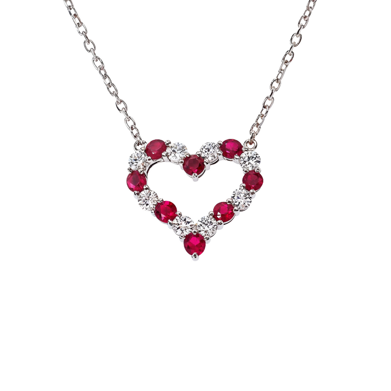 Heart-shaped necklace with alternating ruby and diamond gemstones on silver chain