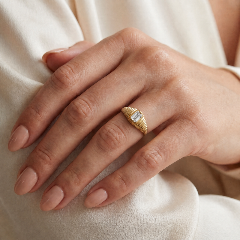 bezel set Diamond pinky signet ring in 14K gold featuring a 0.70 carat emerald-cut lab grown diamond