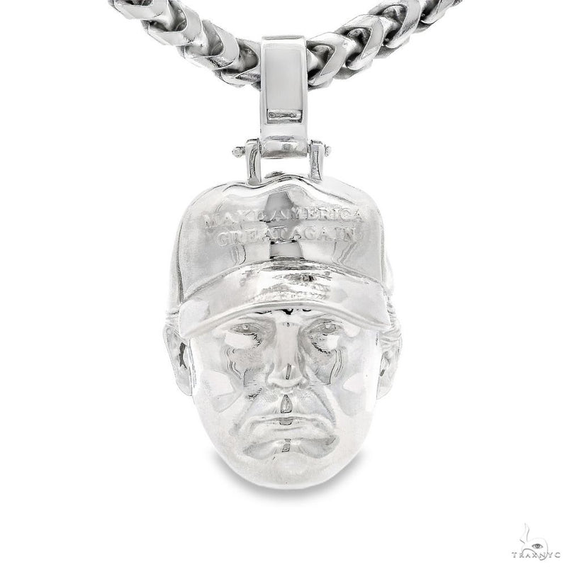Silver pendant shaped like a detailed Donald Trump head on a thick Franco chain necklace