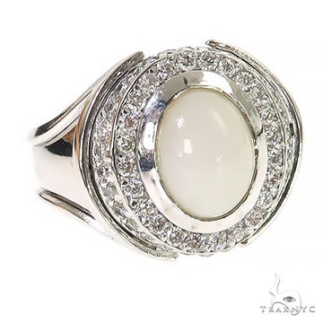 Silver men's ring with oval white opal center and surrounding small clear gemstones.