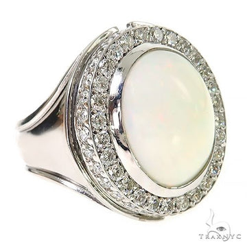 Men’s silver ring with oval opal center and double halo of small clear gemstones.