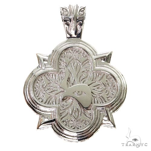 Silver logo pendant showing TraxNYC branding, polished front face, close-up angle