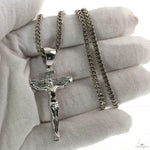 Silver Jesus crucifix pendant with detailed Franco chain necklace.
