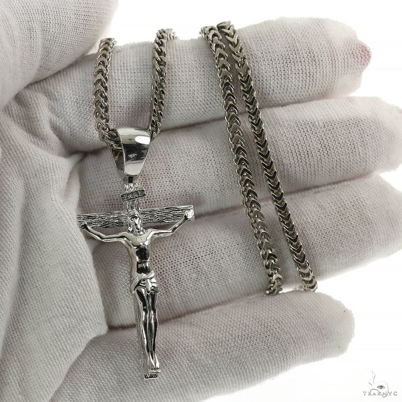 Silver Jesus crucifix pendant with detailed Franco chain necklace.