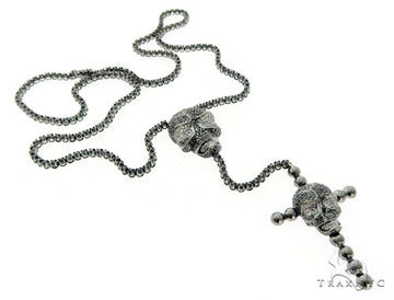 Black diamond skull and cross crucifix pendant on a dark metal chain.