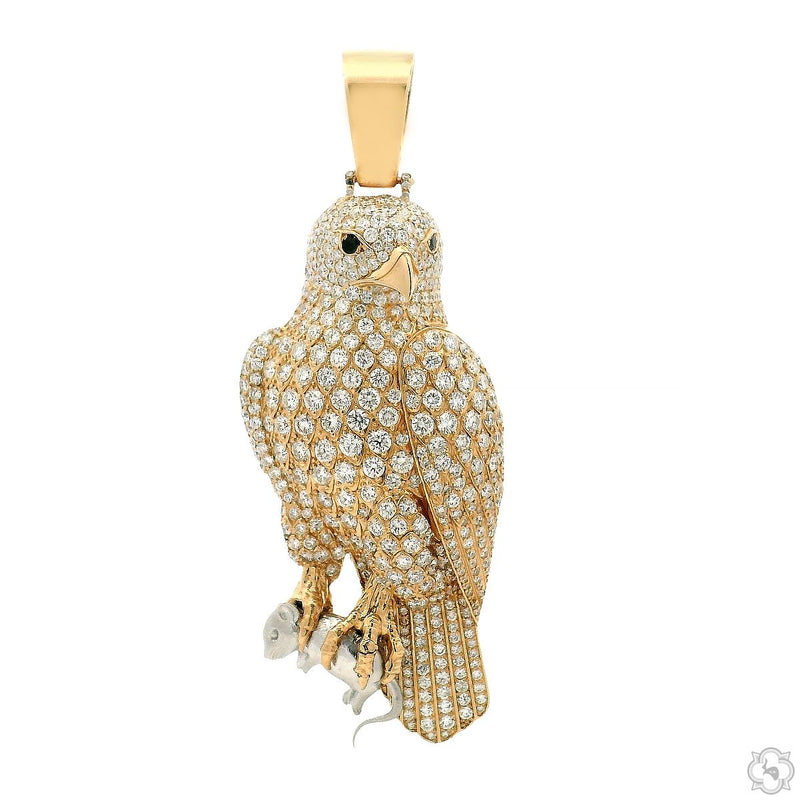 Yellow gold hawk pendant encrusted with diamonds, detailed claws, and black gemstone eyes