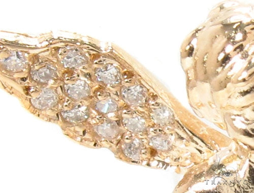 Small 14K yellow gold angel pendant with diamond-studded wings and halo design